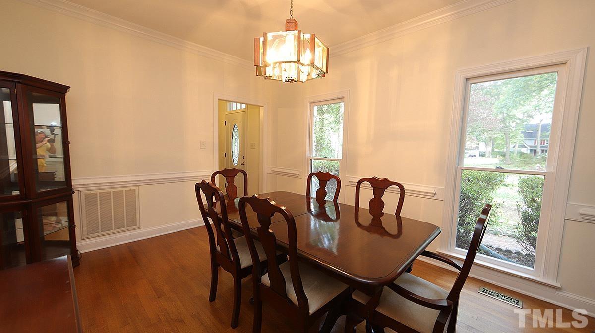 8700 Mourning Dove Road Raleigh, NC 27615 - Photo 8 of 30 a view of a dining room with furniture window and wooden floor