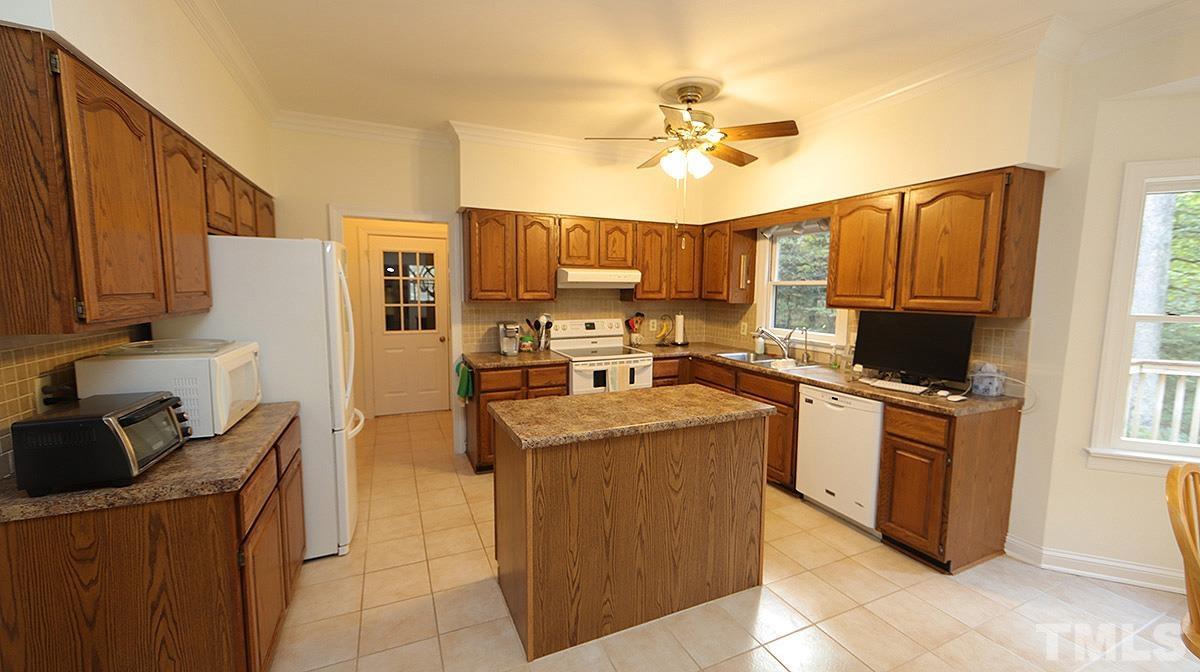 8700 Mourning Dove Road Raleigh, NC 27615 - Photo 9 of 30 a kitchen with stainless steel appliances granite countertop a stove top oven a refrigerator a sink and dishwasher