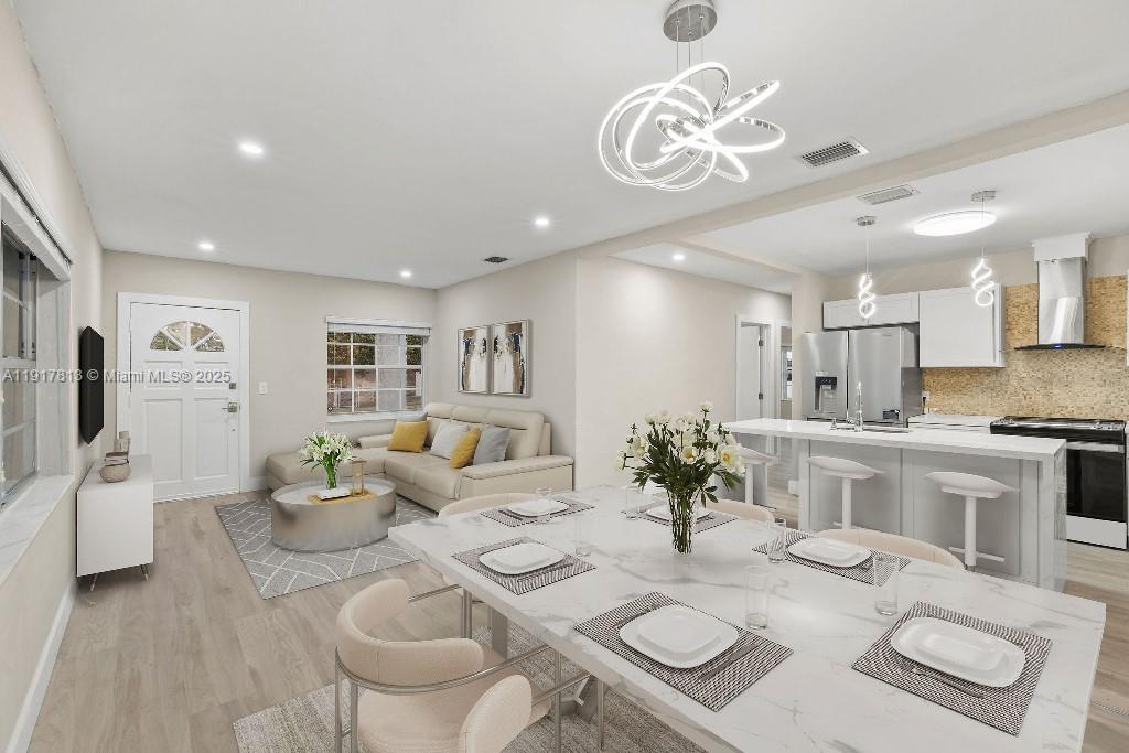 a living room with furniture a dining table and kitchen view