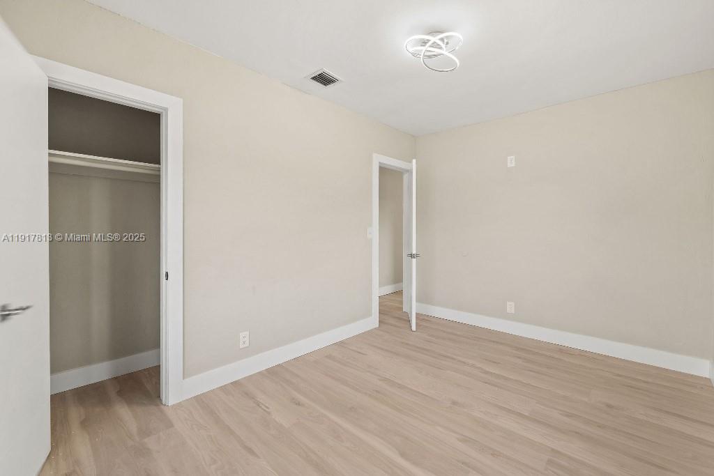 14760 Fillmore Street Miami, FL 33176 - Photo 12 of 23 an empty room with wooden floor and closet