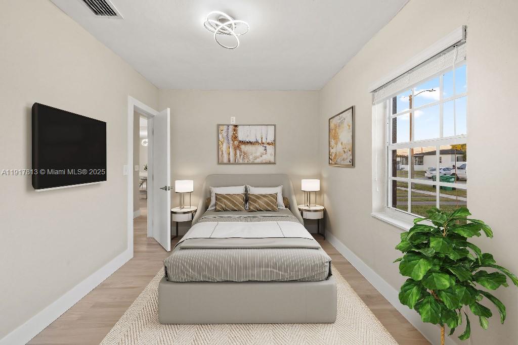 14760 Fillmore Street Miami, FL 33176 - Photo 13 of 23 a spacious bedroom with a bed and a potted plant
