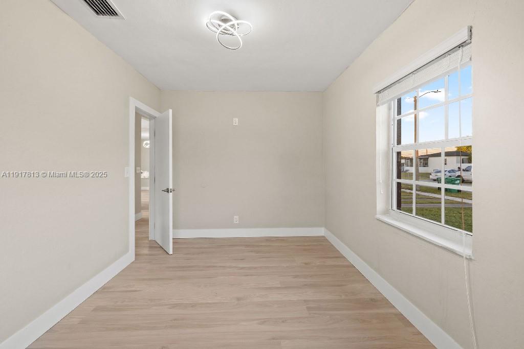 14760 Fillmore Street Miami, FL 33176 - Photo 14 of 23 an empty room with wooden floor and windows