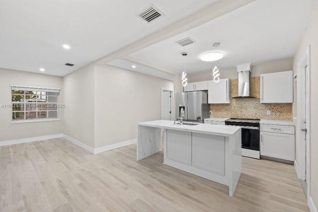 14760 Fillmore Street Miami, FL 33176 - Photo 17 of 23 a kitchen with a sink cabinets stainless steel appliances and a window