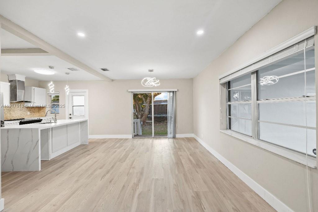 14760 Fillmore Street Miami, FL 33176 - Photo 4 of 23 a large space with kitchen view and wooden floor