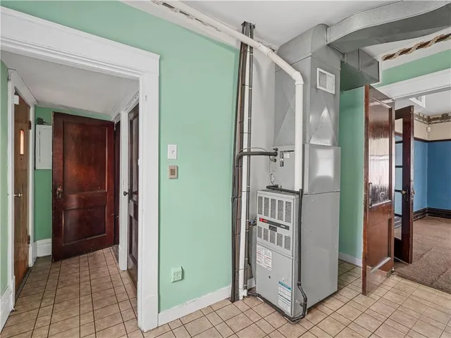 a view of walk in closet and chandelier