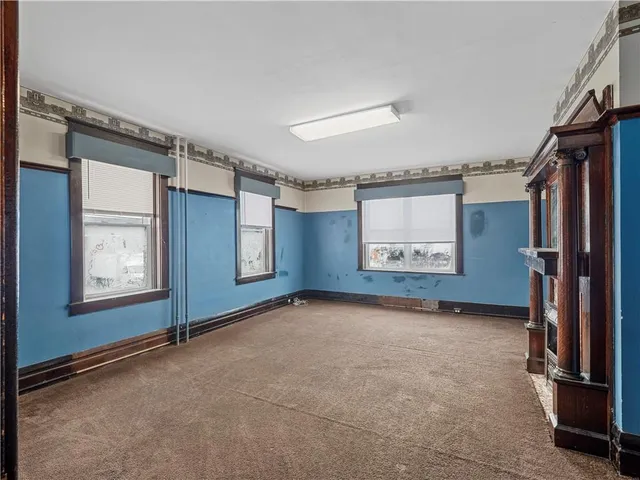 an empty room with fireplace