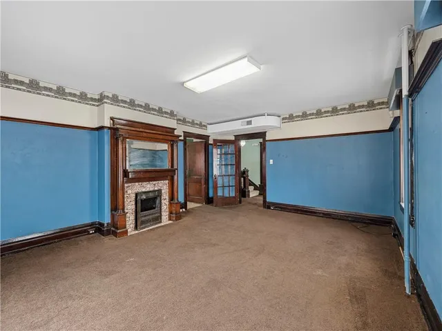 an empty room with windows and closet