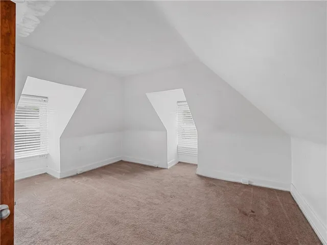 a view of empty room with wooden walls