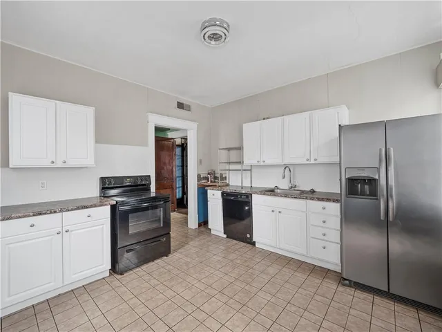 a kitchen with cabinets stainless steel appliances and a counter space