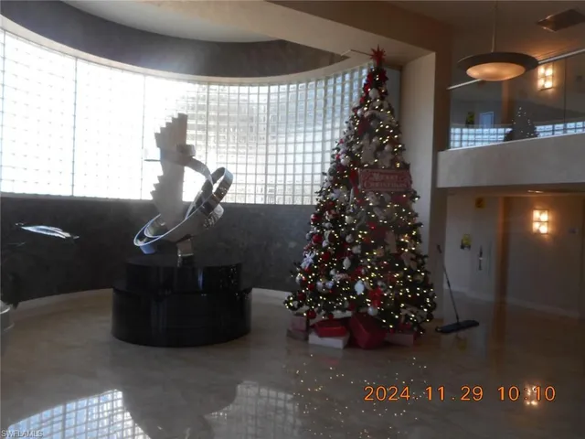 a view of a patio with table and chairs under an umbrella with a barbeque grill