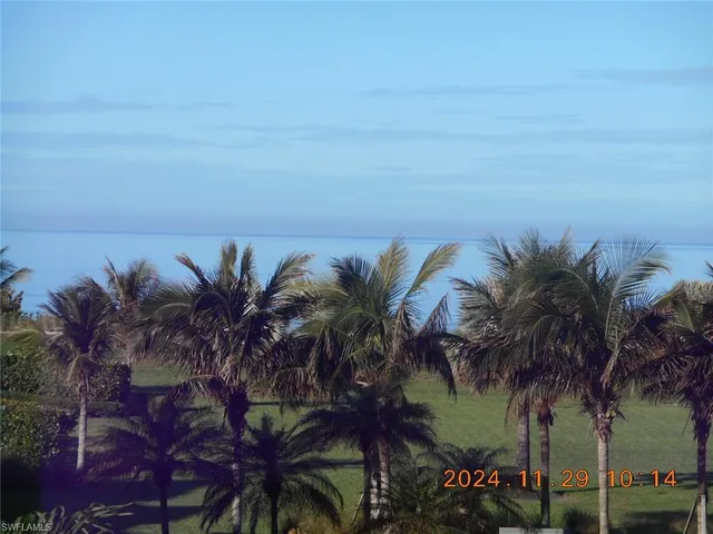 a view of a porch with furniture and floor to ceiling window