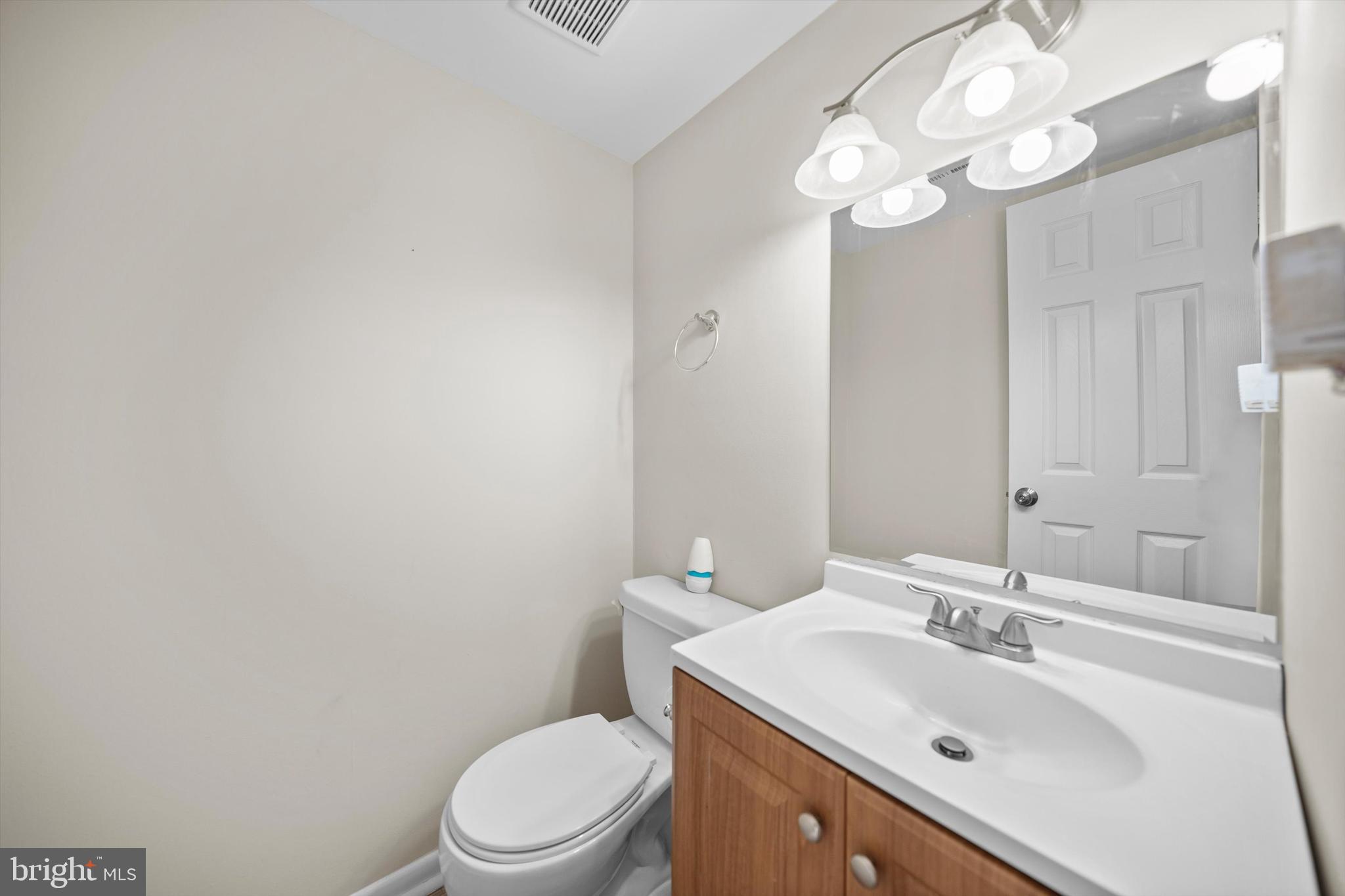 14640 Endsley Turn Woodbridge, VA 22193 - Photo 5 of 27 a bathroom with a sink vanity mirror and toilet