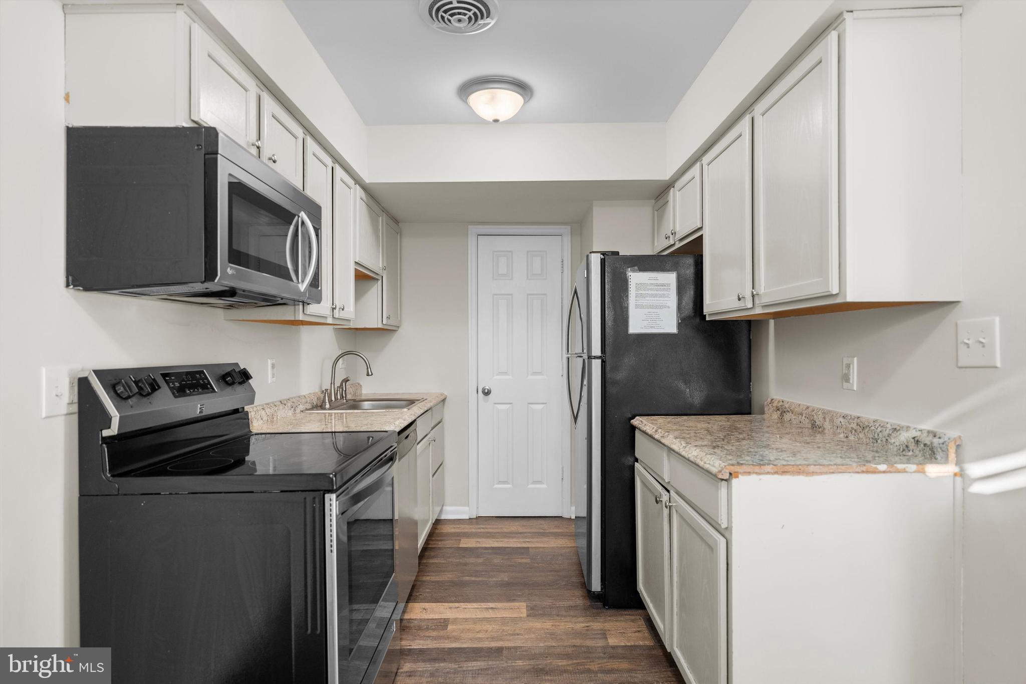 14640 Endsley Turn Woodbridge, VA 22193 - Photo 9 of 27 a kitchen with stainless steel appliances granite countertop a stove microwave and sink
