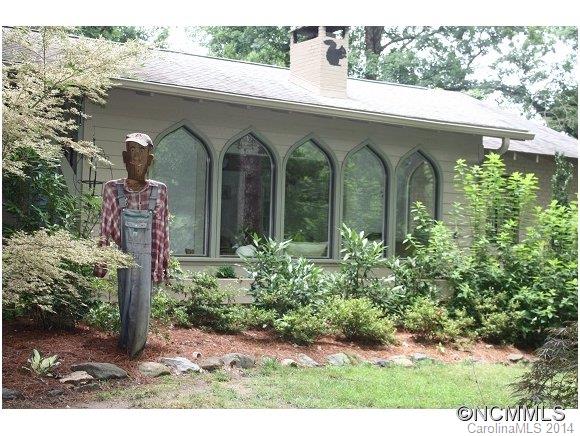 105 Hunting Country Road Tryon, NC 28782 - Photo 1 of 16 a front view of a house with garden