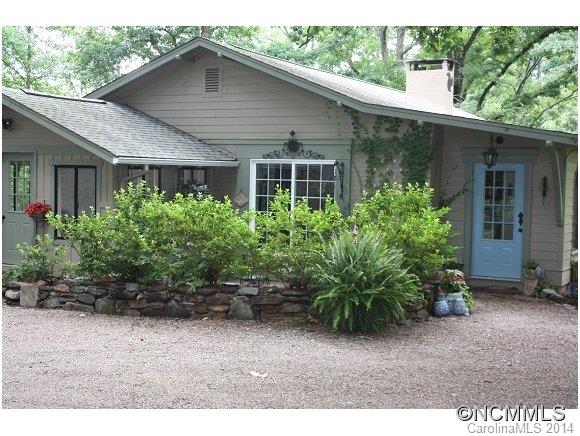 105 Hunting Country Road Tryon, NC 28782 - Photo 2 of 16 a front view of house with yard and green space