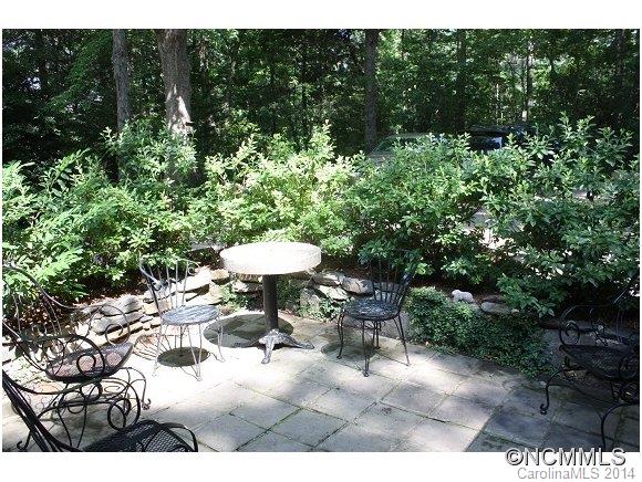 105 Hunting Country Road Tryon, NC 28782 - Photo 11 of 16 a view of a patio with furniture and a garden
