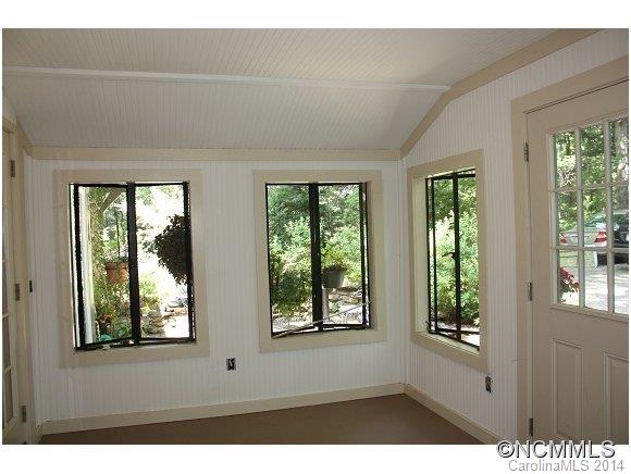 105 Hunting Country Road Tryon, NC 28782 - Photo 12 of 16 a view of an empty room with large windows