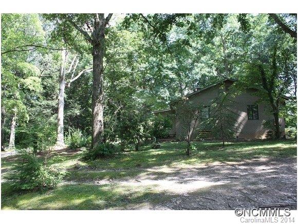 105 Hunting Country Road Tryon, NC 28782 - Photo 15 of 16 a backyard of a house with lots of green space