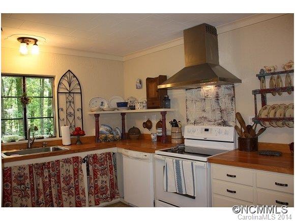105 Hunting Country Road Tryon, NC 28782 - Photo 4 of 16 a kitchen with a sink and a stove next to a window