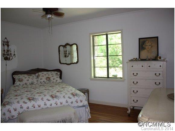 105 Hunting Country Road Tryon, NC 28782 - Photo 7 of 16 a bedroom with a bed and a window