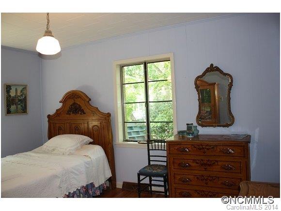 105 Hunting Country Road Tryon, NC 28782 - Photo 8 of 16 a bedroom with a bed and a window