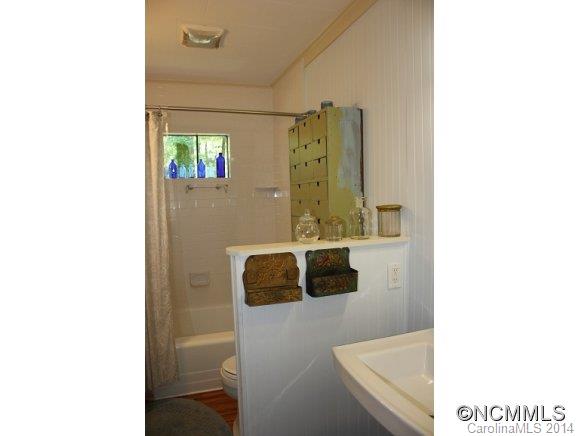 105 Hunting Country Road Tryon, NC 28782 - Photo 10 of 16 a bathroom with a sink and a mirror