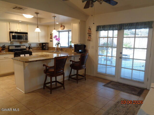 43043 Flag Street Lancaster, CA 93536 - Photo 12 of 29 a kitchen with a sink cabinets and dining table chair