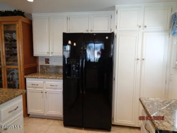 a kitchen with a refrigerator and cabinets