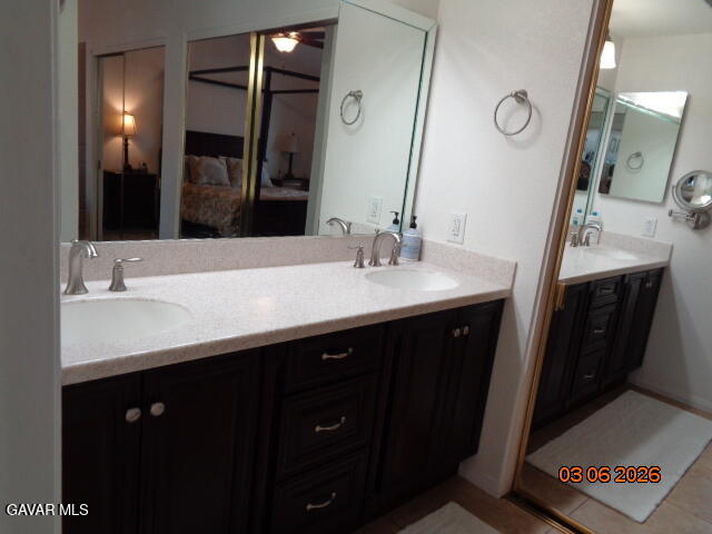43043 Flag Street Lancaster, CA 93536 - Photo 23 of 29 a bathroom with a double vanity sink and a mirror