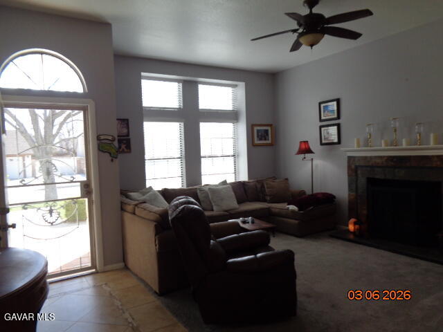 43043 Flag Street Lancaster, CA 93536 - Photo 25 of 29 a living room with furniture a fireplace and a floor to ceiling window