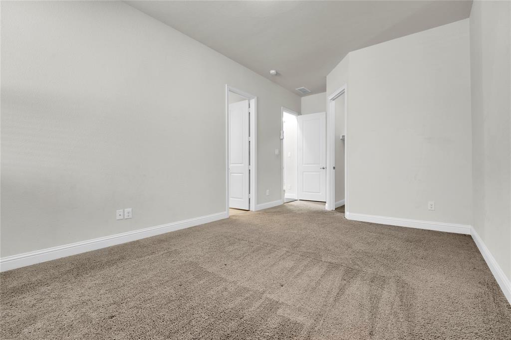 1011 Prairie Ridge Lane Arlington, TX 76005 - Photo 12 of 32 Spacious room featuring neutral carpeting, light gray wall paint, and white baseboards