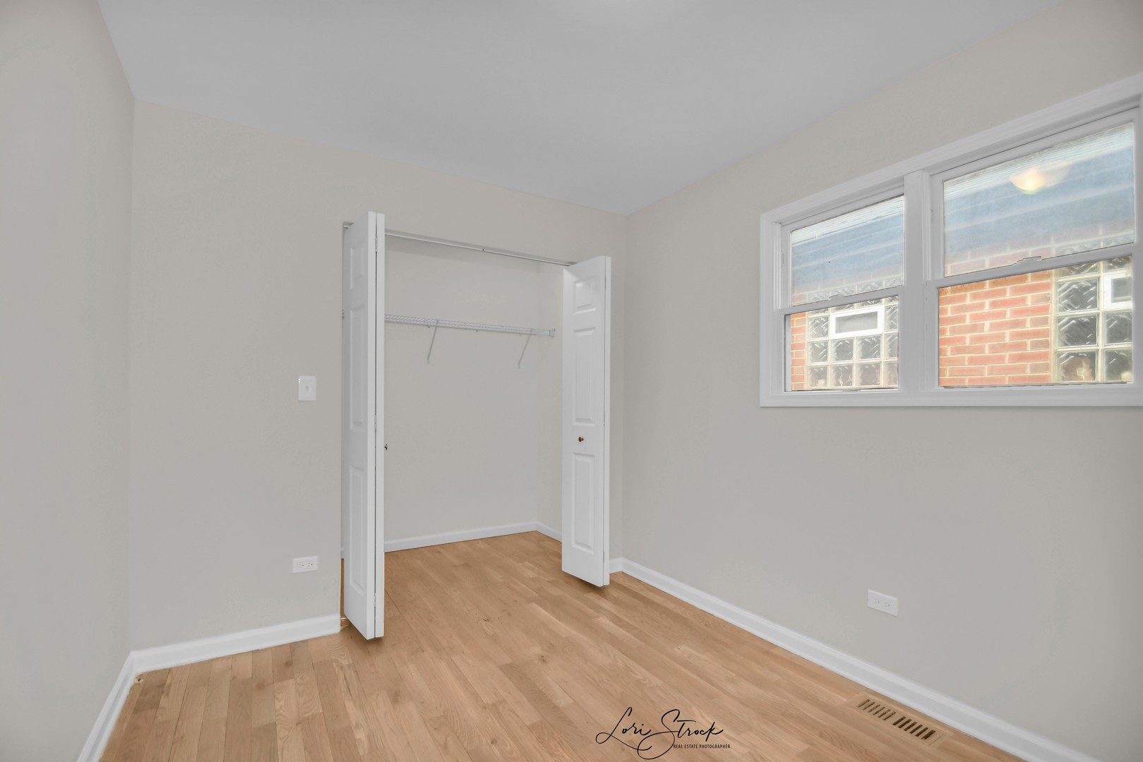 5525 South Emerald Avenue Chicago, IL 60621 - Photo 11 of 29 an empty room with wooden floor and windows