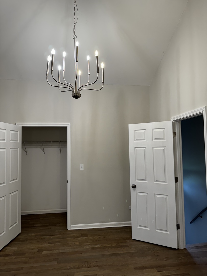 5525 South Emerald Avenue Chicago, IL 60621 - Photo 14 of 29 a room with wooden floor and white wall