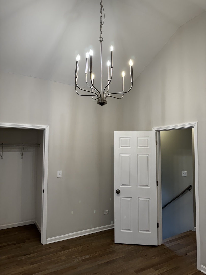 5525 South Emerald Avenue Chicago, IL 60621 - Photo 15 of 29 a view of a room with wooden floor and staircase