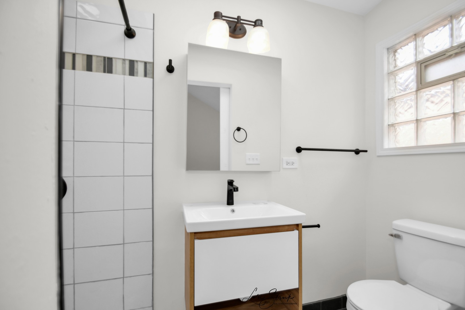 5525 South Emerald Avenue Chicago, IL 60621 - Photo 16 of 29 a bathroom with a sink a toilet and window