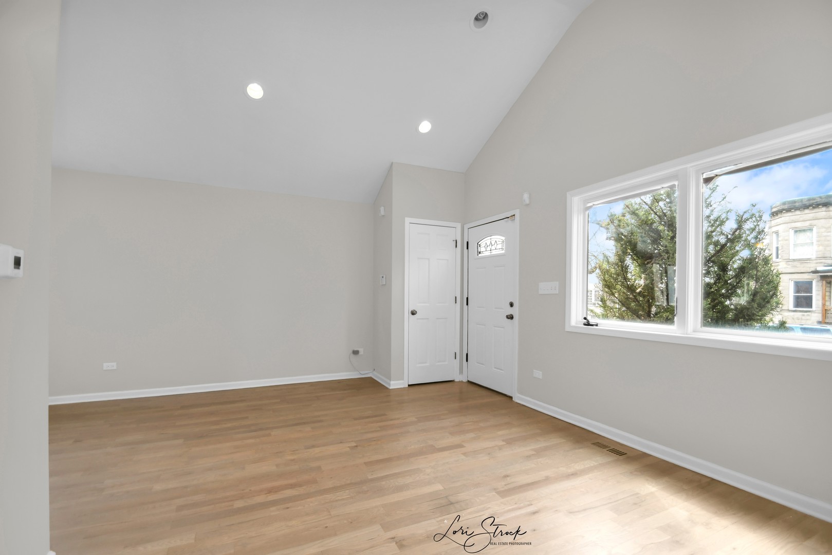 5525 South Emerald Avenue Chicago, IL 60621 - Photo 18 of 29 an empty room with wooden floor and windows