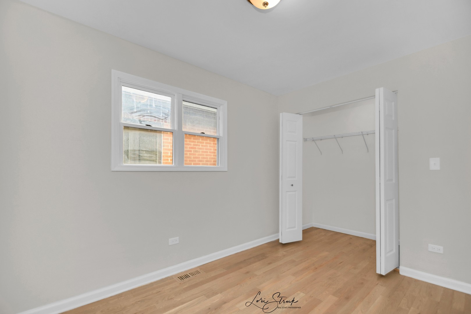 5525 South Emerald Avenue Chicago, IL 60621 - Photo 9 of 29 an empty room with wooden floor and windows
