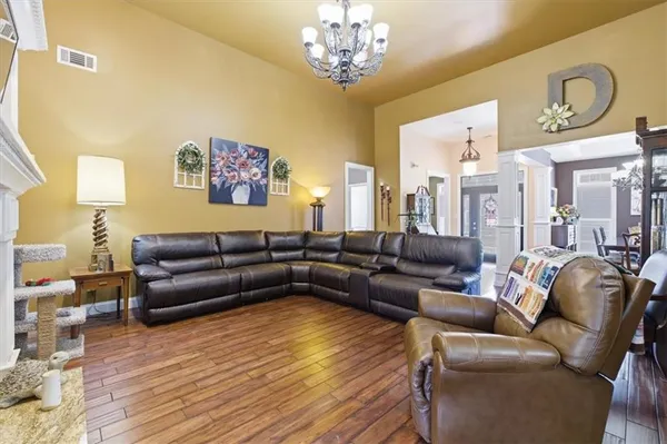 a living room with furniture or couch and a chandelier