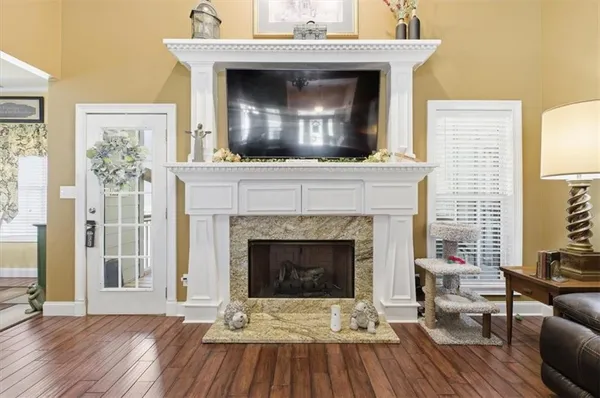 a living room with a fireplace and a wooden floor