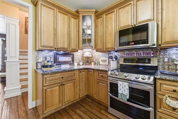 a kitchen with stainless steel appliances a stove a microwave and cabinets