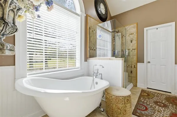 a white bath tub sitting next to a window