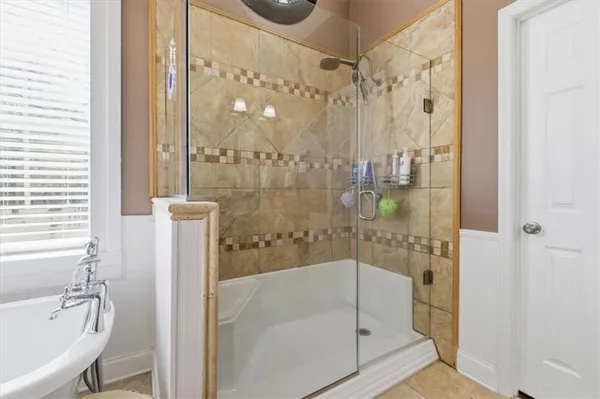 a bathroom with a bathtub and a shower