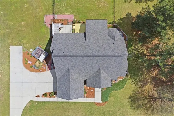 an aerial view of a house with outdoor space pool seating area and fire pit