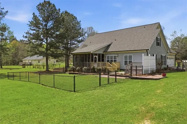 a view of a house with furniture and garden