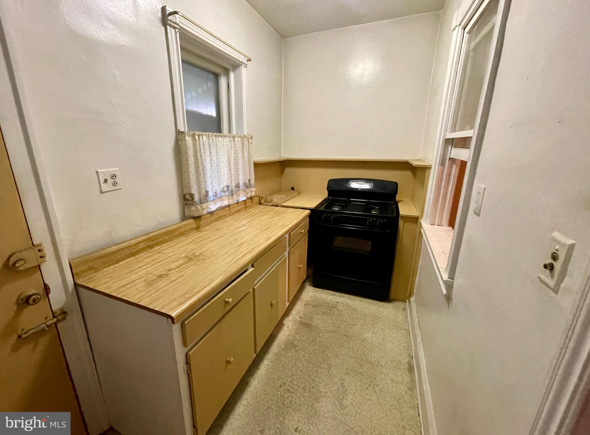 208 North 63rd Street Philadelphia, PA 19139 - Photo 15 of 29 a kitchen with a stove a refrigerator and a sink