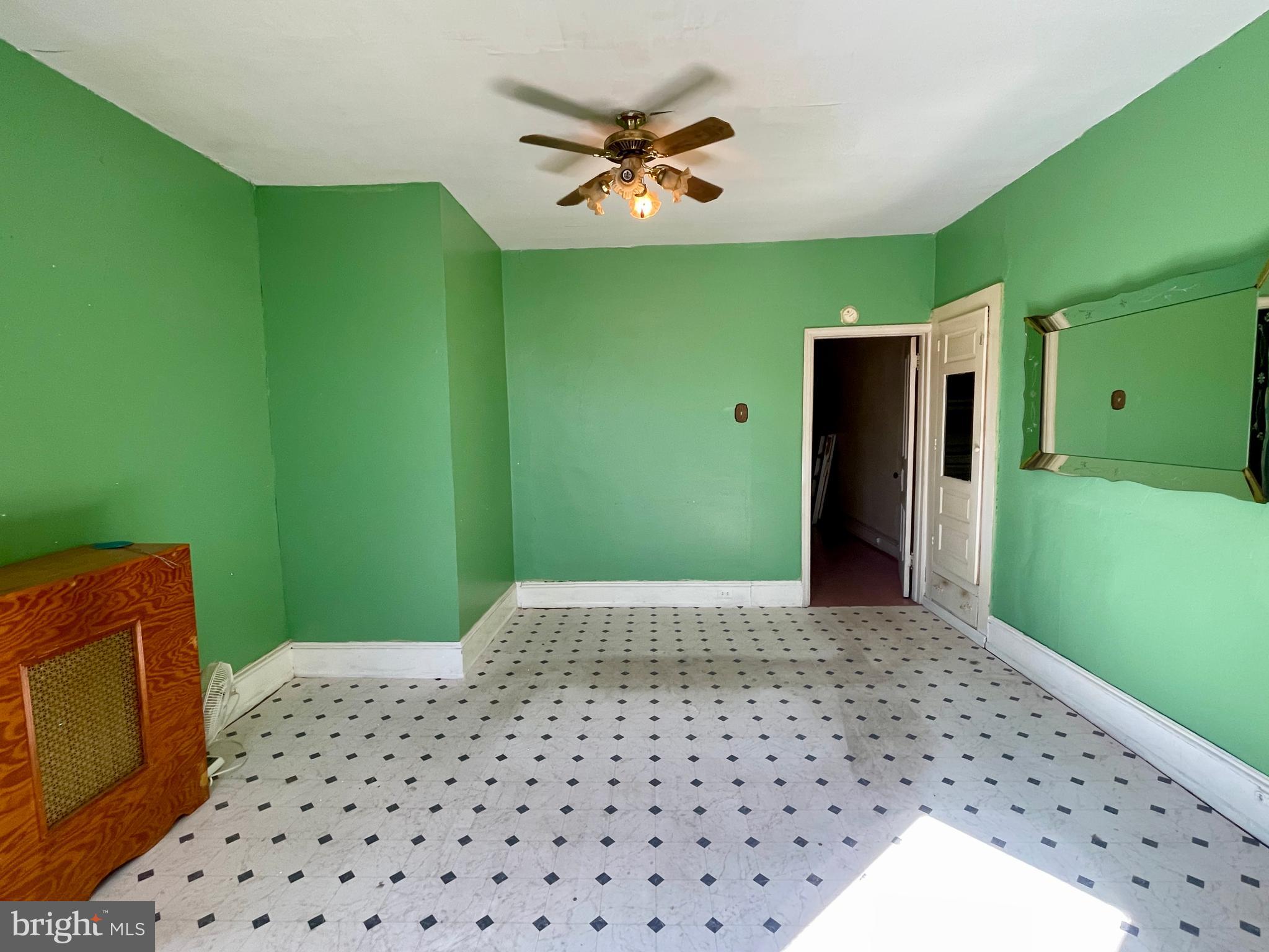 208 North 63rd Street Philadelphia, PA 19139 - Photo 18 of 29 a bedroom with a large bed and a chandelier