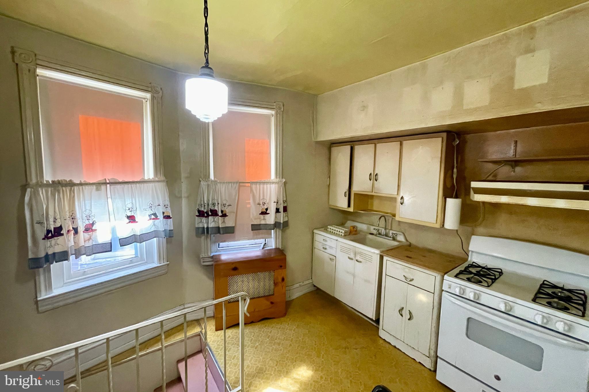 208 North 63rd Street Philadelphia, PA 19139 - Photo 19 of 29 a kitchen with stainless steel appliances granite countertop a sink a stove and a wooden floors