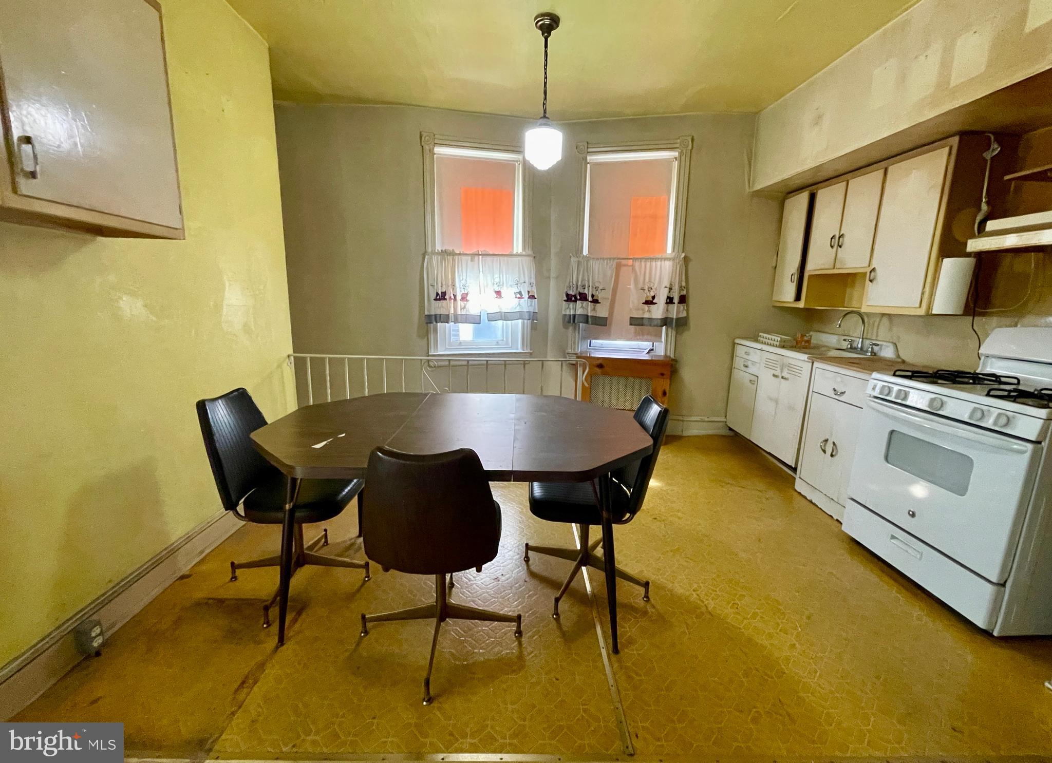 208 North 63rd Street Philadelphia, PA 19139 - Photo 21 of 29 a dining room with a table chairs and a kitchen view