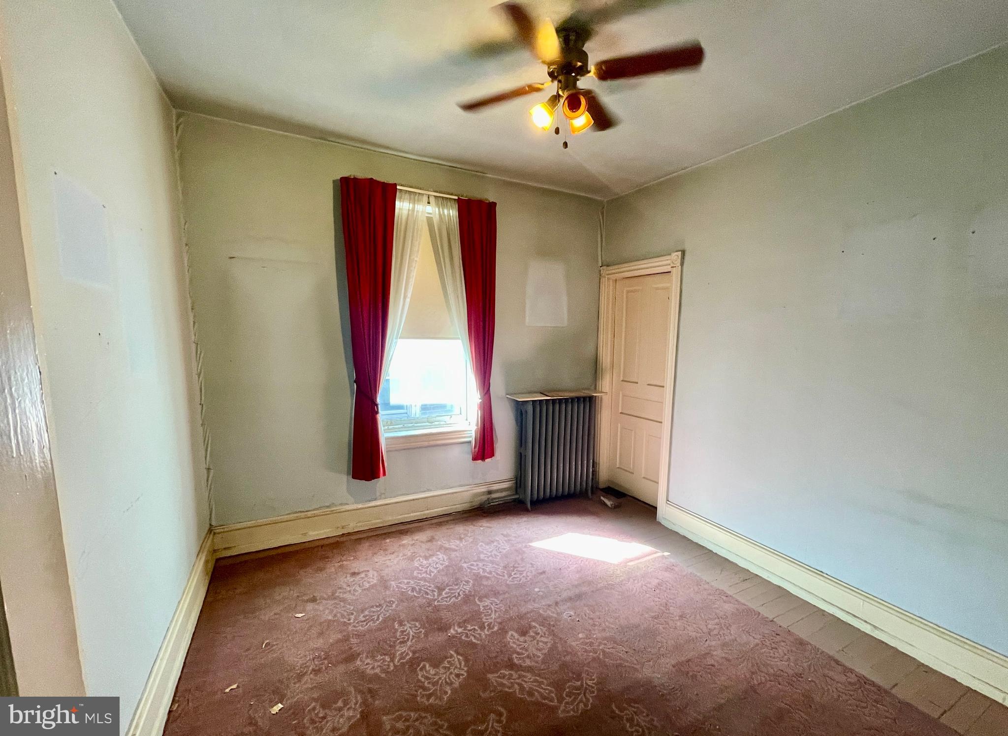 208 North 63rd Street Philadelphia, PA 19139 - Photo 23 of 29 an empty room with windows and fan