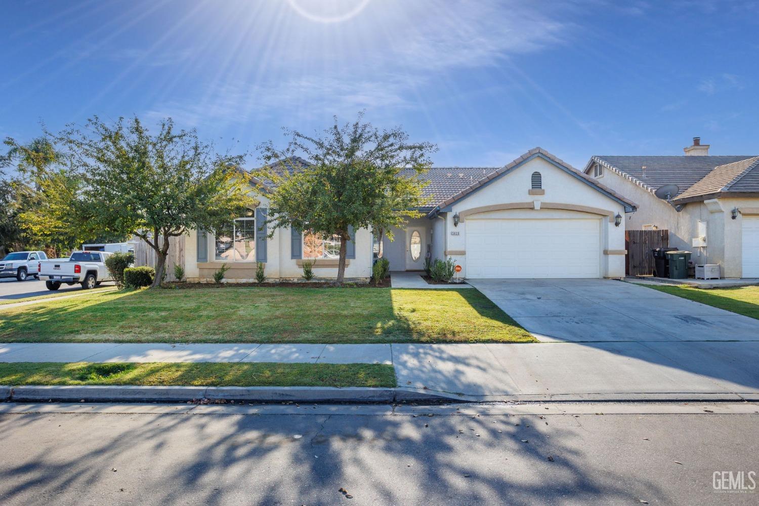 Undisclosed Address Bakersfield, CA 93312 - Photo 1 of 45 a view of a house with a yard and plants